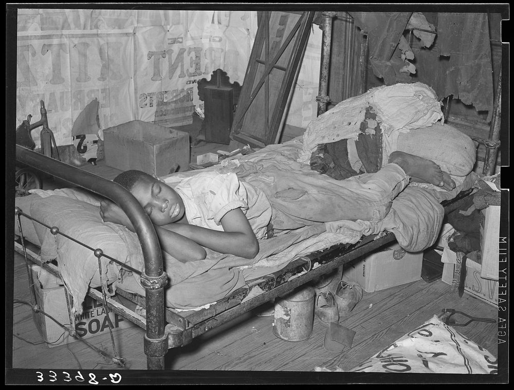 Laborer taking a nap in his home. Muskogee, Oklahoma. Muskogee County by Russell Lee