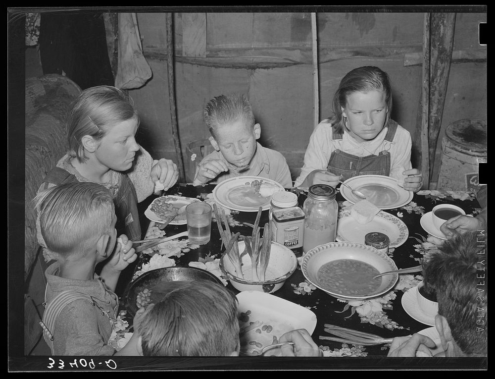 Children of agricultural day laborer eating their noonday meal near Webbers Falls, Oklahoma. Muskogee County by Russell Lee