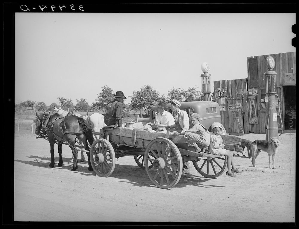 [Untitled photo, possibly related to: Farmer's wagon loaded with supplies leaving crossroads store in McIntosh County…