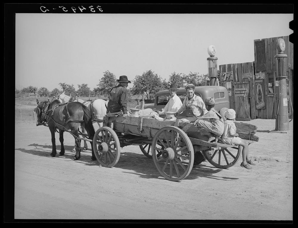 Farmer's wagon loaded with supplies leaving crossroads store in McIntosh County, Oklahoma by Russell Lee