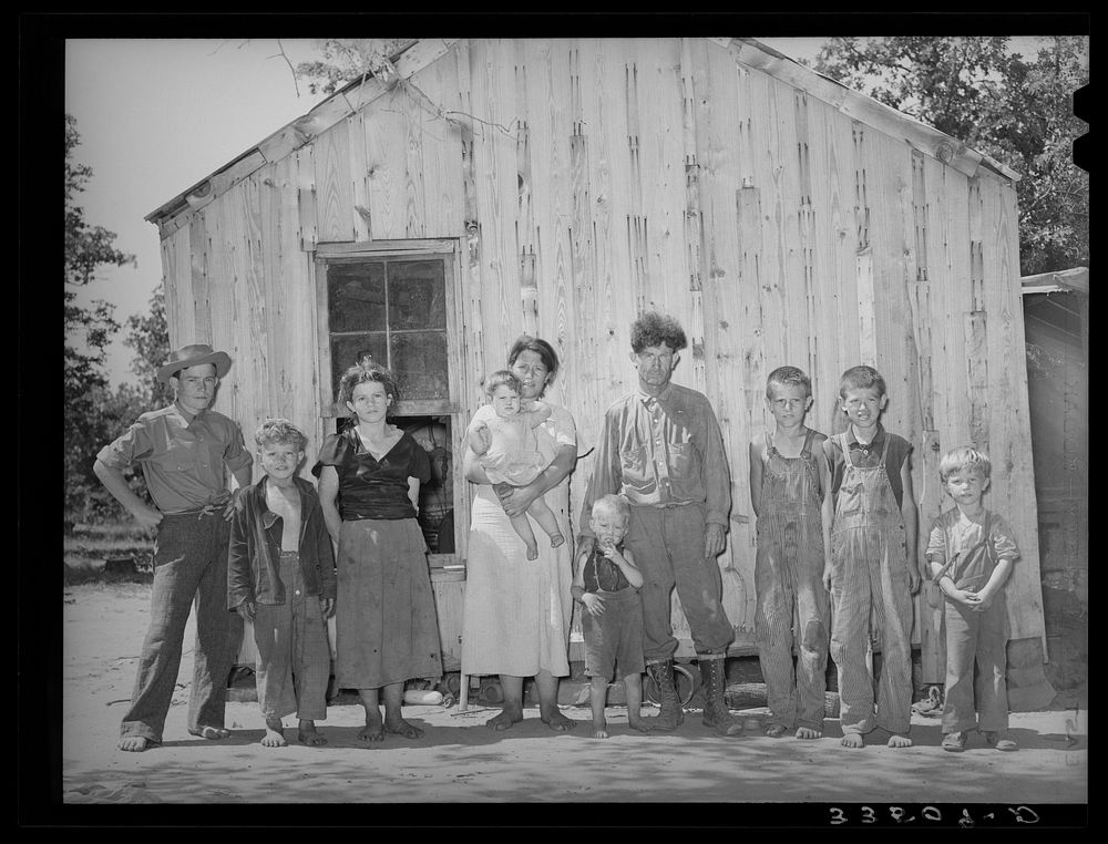 Family of agricultural day laborer, former oil worker and coal miner. The family lives in this two-room shack in McIntosh…