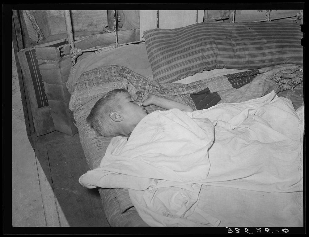 [Untitled photo, possibly related to: Boy asleep in house in Arkansas River bottom near Vian. Oklahoma, Sequoyah County] by…