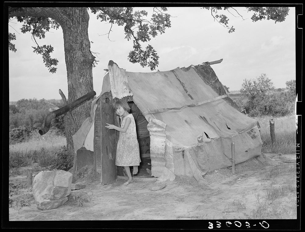 Daughter of agricultural day laborer coming out of tent where her uncle slept. Poteau Creek near Spiro, Oklahoma by Russell…