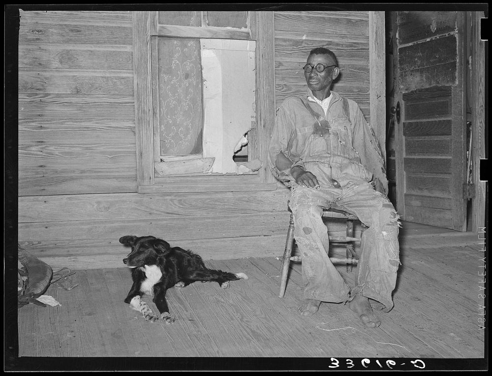 Old man and his dog. He is a tenant farmer living in Wagoner County, Oklahoma by Russell Lee