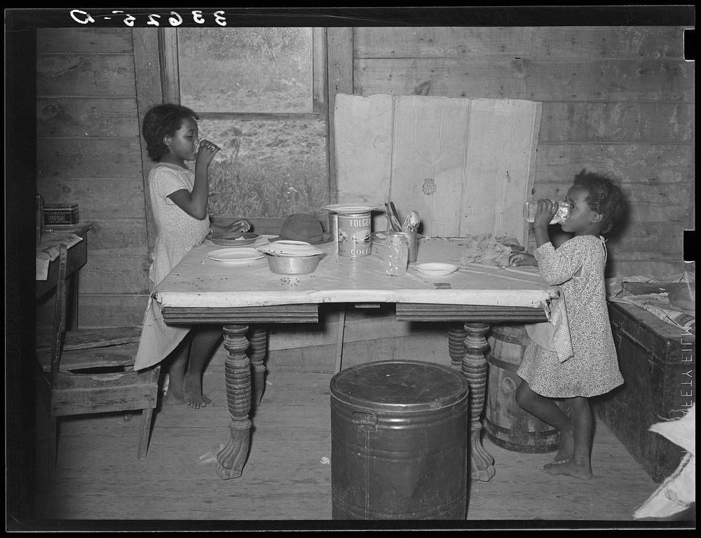 Children of  tenant farmer eating lunch. Lunch consisted of bread and flour gravy. Wagoner County, Oklahoma by Russell Lee