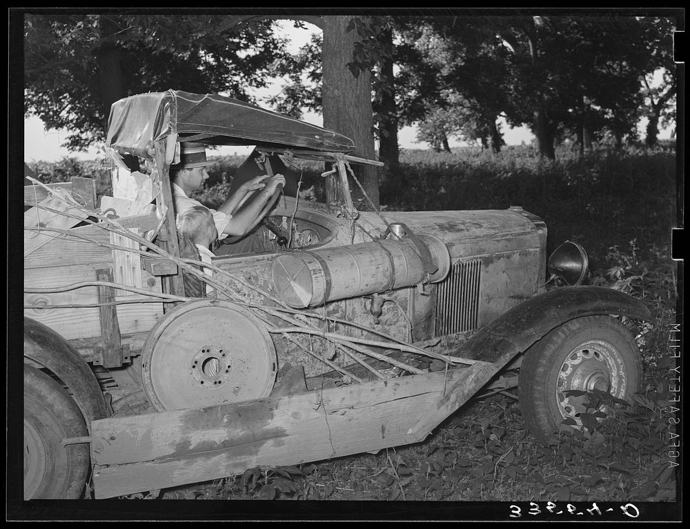 Migrant agricultural worker from Texas in his automobile in Wagoner County, near Tullahassee, Oklahoma by Russell Lee