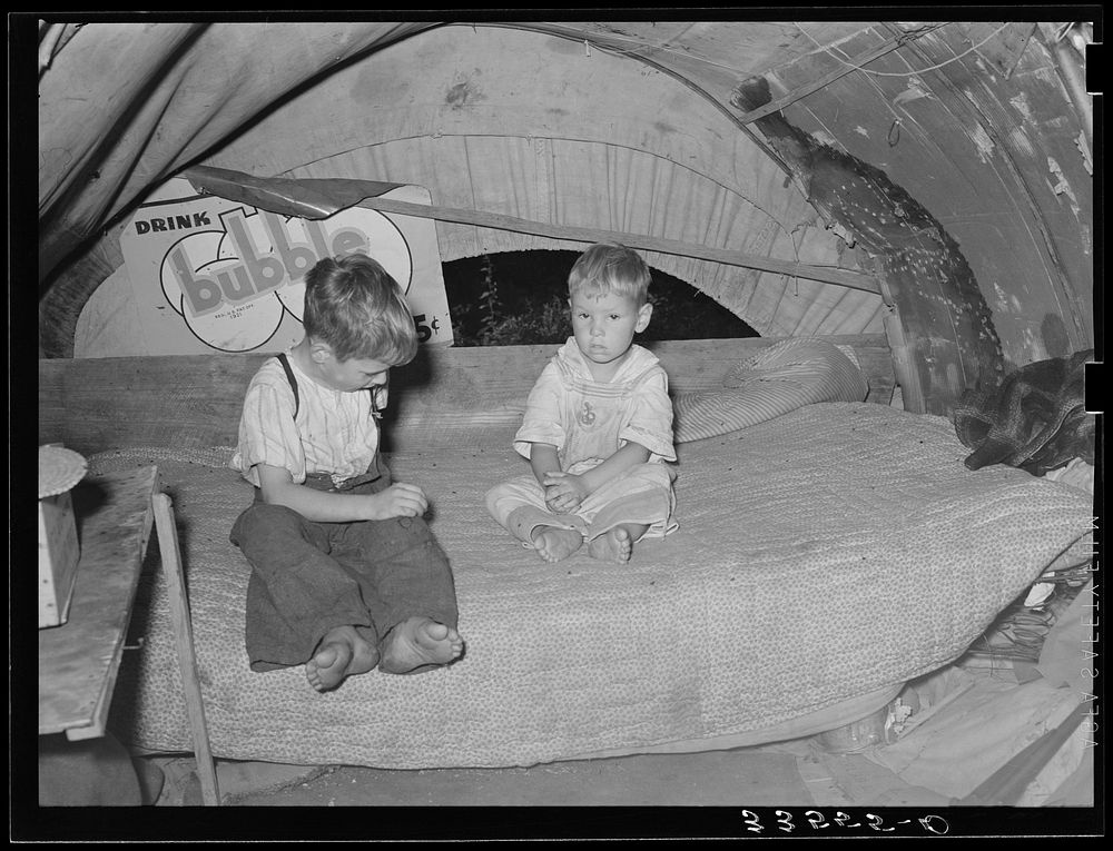 Children of migrant from Texas in their trailer home near Tullahassee, Oklahoma. The mother is dead by Russell Lee