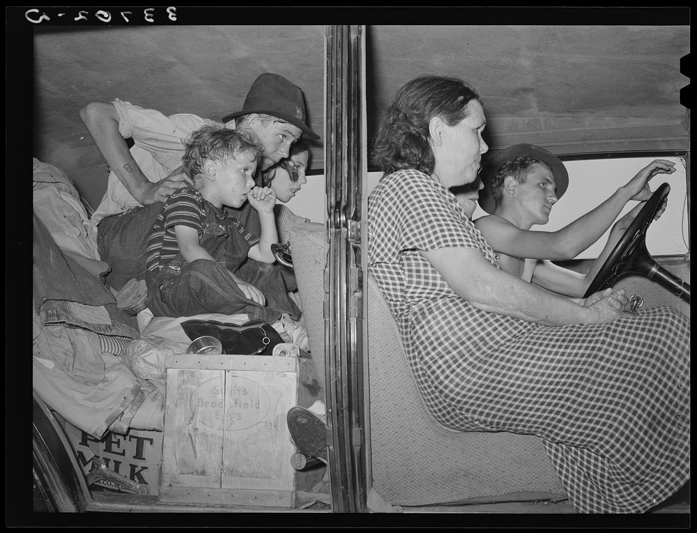 Migrants packed into their automobile near Muskogee, Oklahoma. Muskogee County by Russell Lee