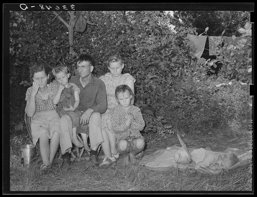 Family of migrant agricultural day laborers camped near Spiro, Oklahoma. The man and his wife had farmed in this vicinity…
