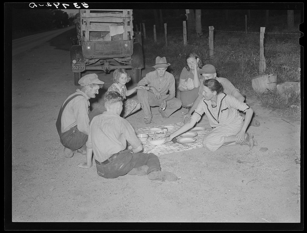 Migrant family encamped along roadside eating meal. Near Henryetta, Oklahoma by Russell Lee