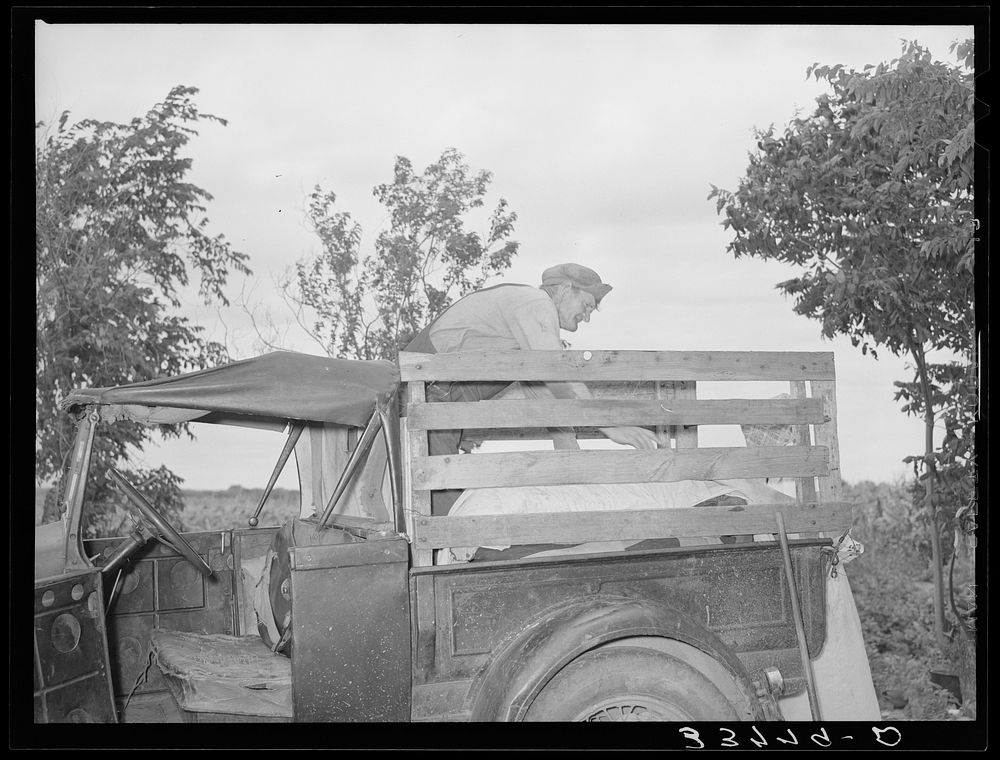 [Untitled photo, possibly related to: Migrant family loading truck preparatory to departure for California. Near Muskogee…