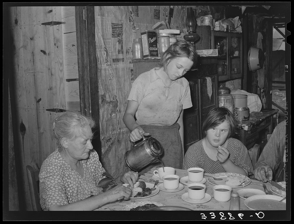 Daughter of tenant farmer pouring coffee at noonday meal. Near Muskogee, Oklahoma. See general caption number 20 by Russell…