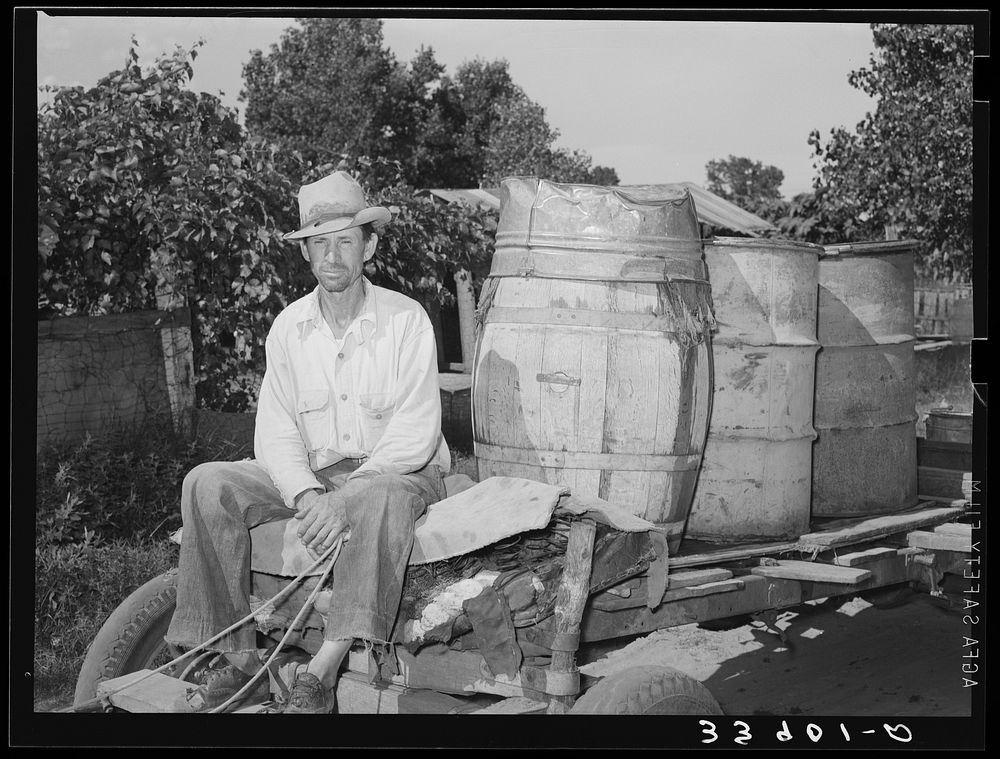 [Untitled photo, possibly related to: Water peddler in community camp. Oklahoma City, Oklahoma. He is paid fifteen cents a…