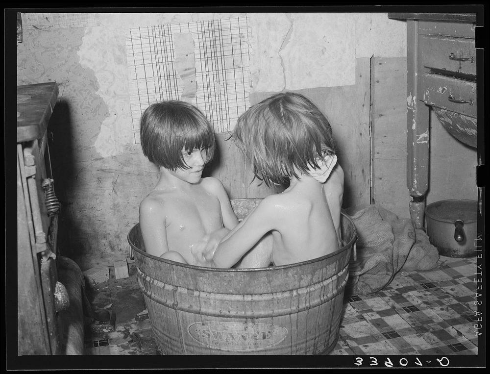[Untitled photo, possibly related to: Children taking bath in their home in community camp. Oklahoma City, Oklahoma. See…