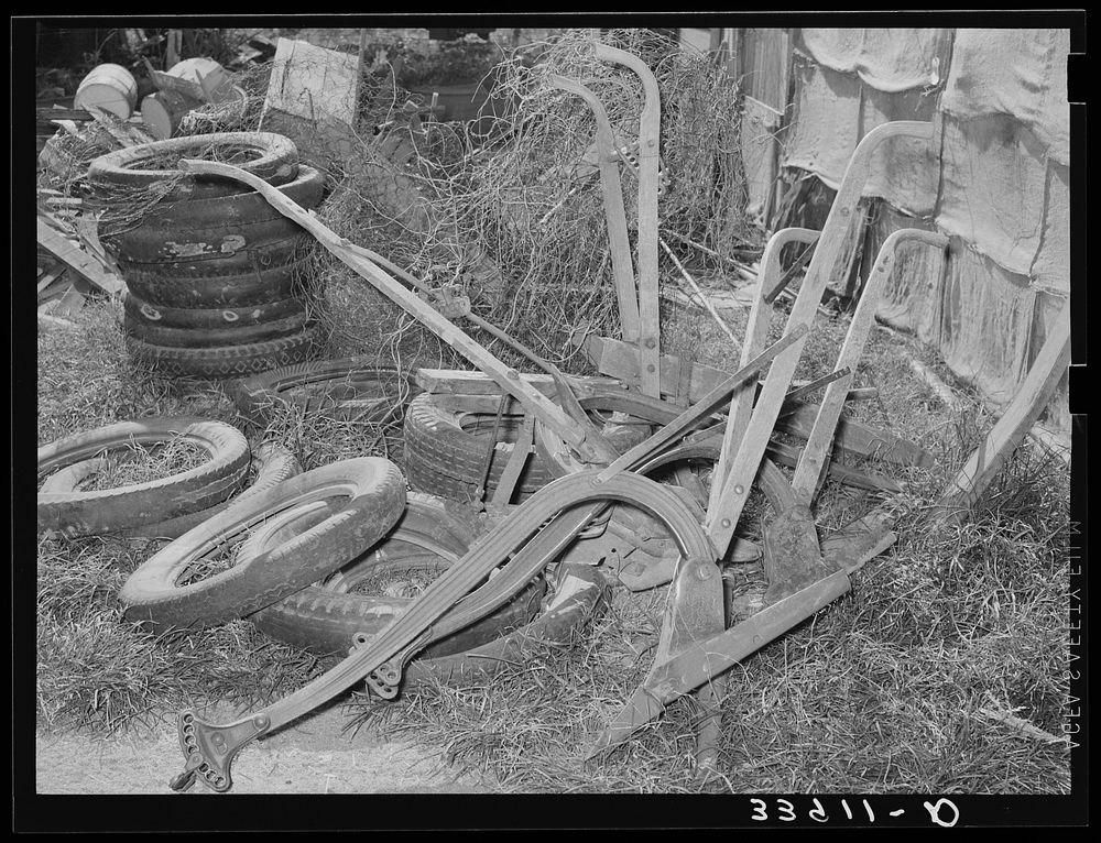 Old plows and wornout tires. Testimonial to the sources of the residents of the community camp. Oklahoma City, Oklahoma. See…