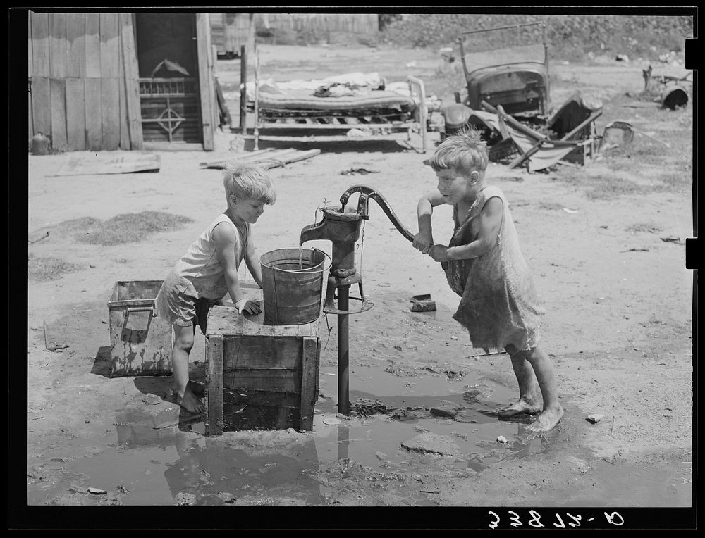 Children of Mays Avenue camp pumping water from thirty-foot well which supplies about a dozen families. Oklahoma City…