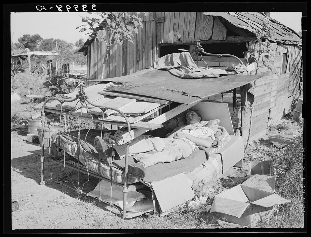 Bed with roof over it in Mays Avenue camp. Oklahoma City, Oklahoma. See general caption 21 by Russell Lee