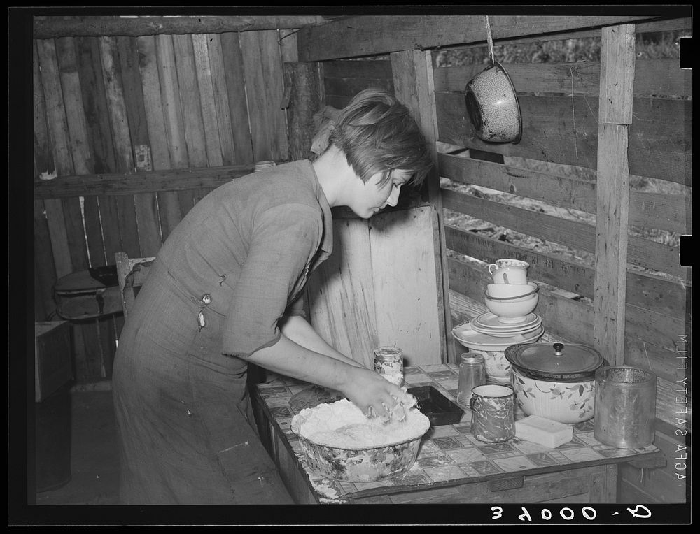 Resident of Mays Avenue camp making biscuits. Oklahoma City, Oklahoma. See general caption no. 21 by Russell Lee