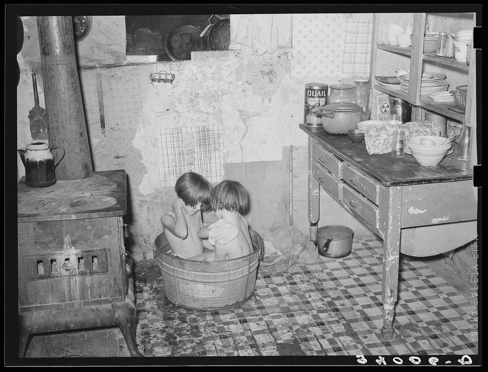 Children taking bath in their home in community camp. Oklahoma City, Oklahoma. See general caption 21 by Russell Lee