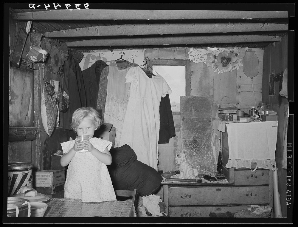 Interior of shack home, Mays Avenue camp. Little girl is daughter of former farmer. Oklahoma City, Oklahoma by Russell Lee