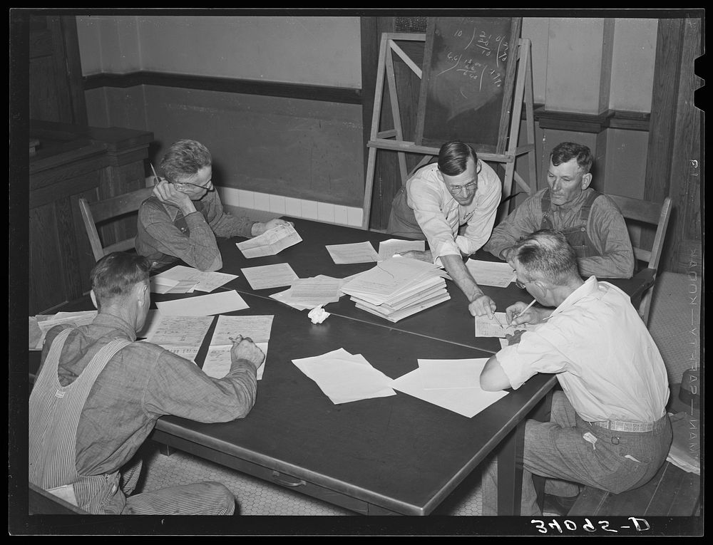 FSA (Farm Security Administration) supervisor explaining plans to clients. Sheridan County, Kansas by Russell Lee