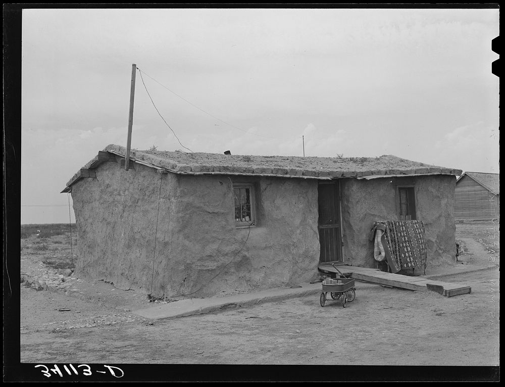 Sod house of the Schoenfeldts, FSA (Farm Security Administration) clients. Sheridan County, Kansas by Russell Lee