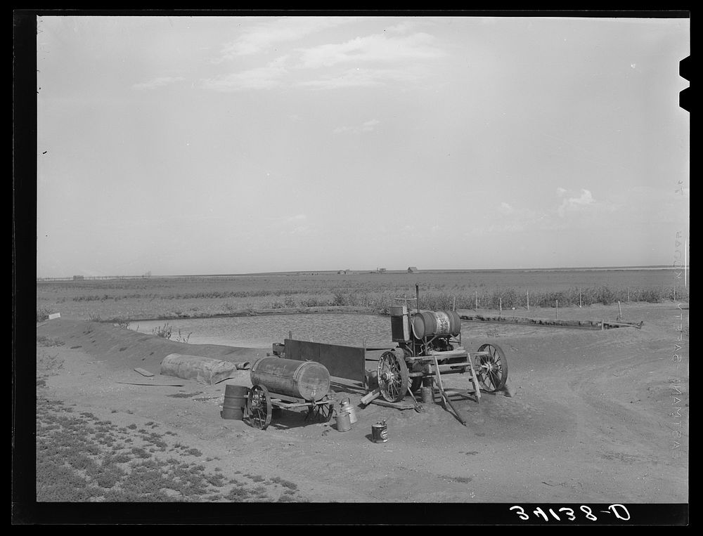Pumping machinery and irrigation pond at cooperative well on the Davidson farm. Near Cimmaron [i.e. Cimarron], Kansas by…