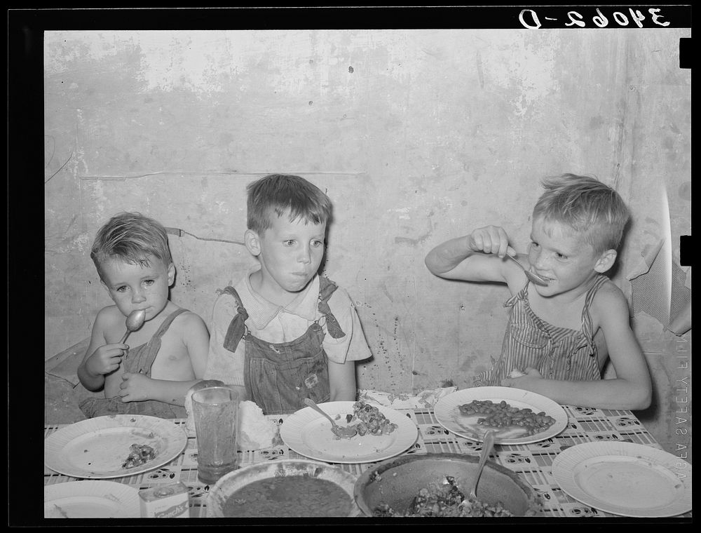 Children of unemployed oil worker eating supper. Seminole, Oklahoma by Russell Lee