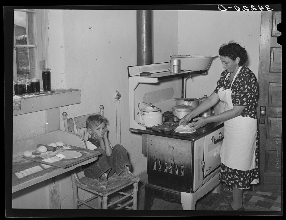 Kitchen scene in Spanish-American home near Taos, New Mexico, Taos County. Making tortillas by Russell Lee