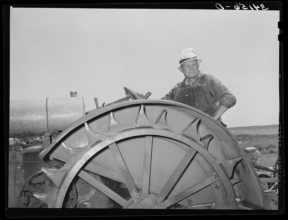 Mr. Bosley, sitting on his tractor. Bosley reorganization unit, Baca County, Colorado by Russell Lee