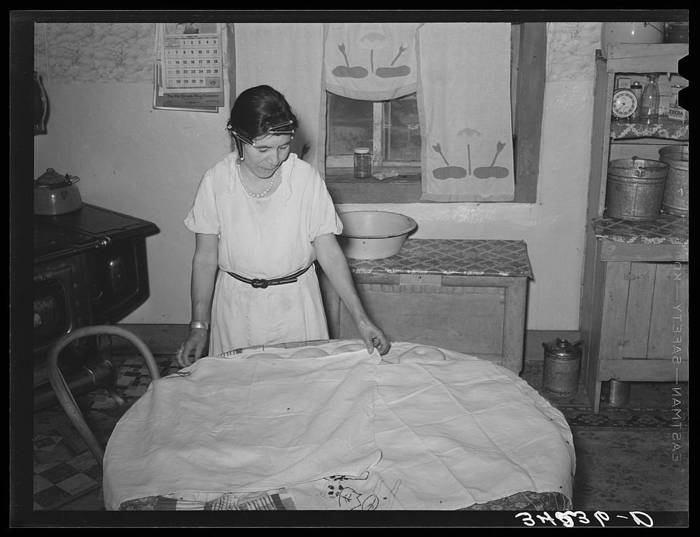 [Untitled photo, possibly related to: Spanish-American woman covering dough so that shaped loaves will rise evenly. Near…