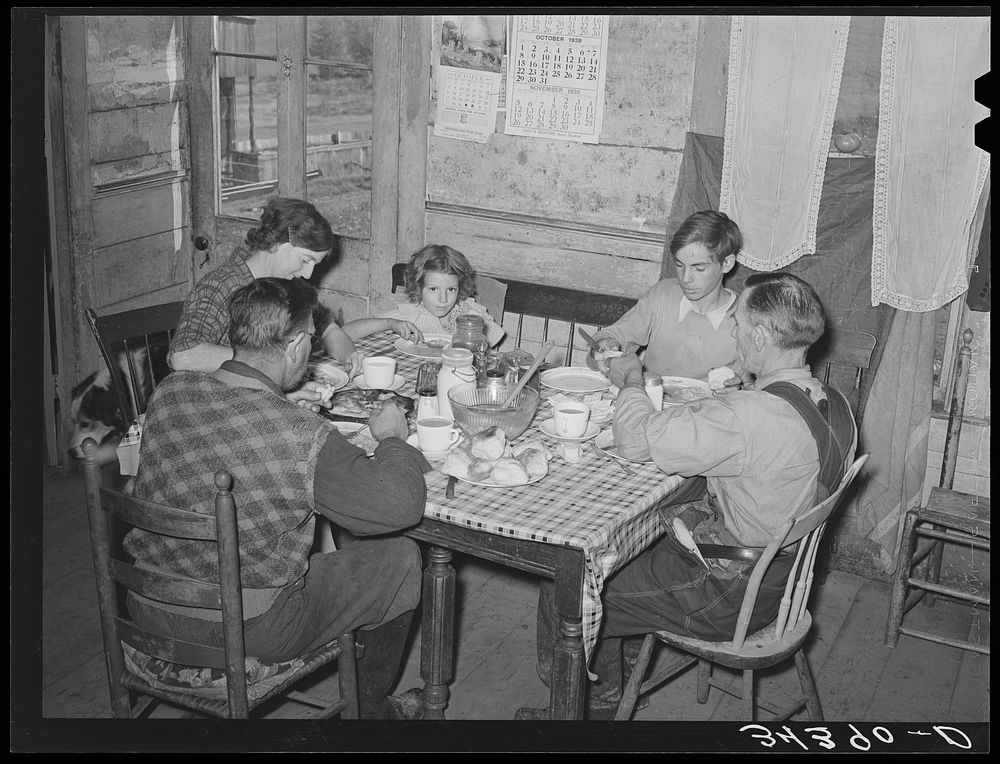 Farm family eating dinner. Orange County, Bradford, Vermont by Russell Lee