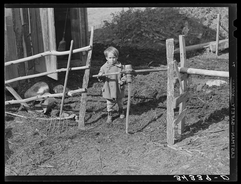 Son of FSA (Farm Security Administration) client going through gate made of old wagon wheel. Farm near Bradford, Vermont…