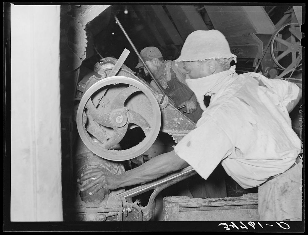 Workers working on machine in cotton seed oil mill. McLennan County, Texas by Russell Lee