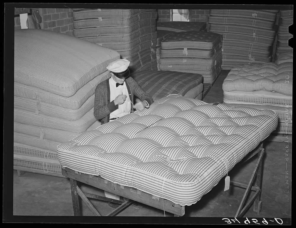 Tufting a mattress. Mattress factory, San Angelo, Texas by Russell Lee