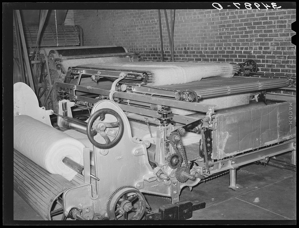 Machine for making cotton bats used for filling mattresses. Mattress factory, San Angelo, Texas by Russell Lee