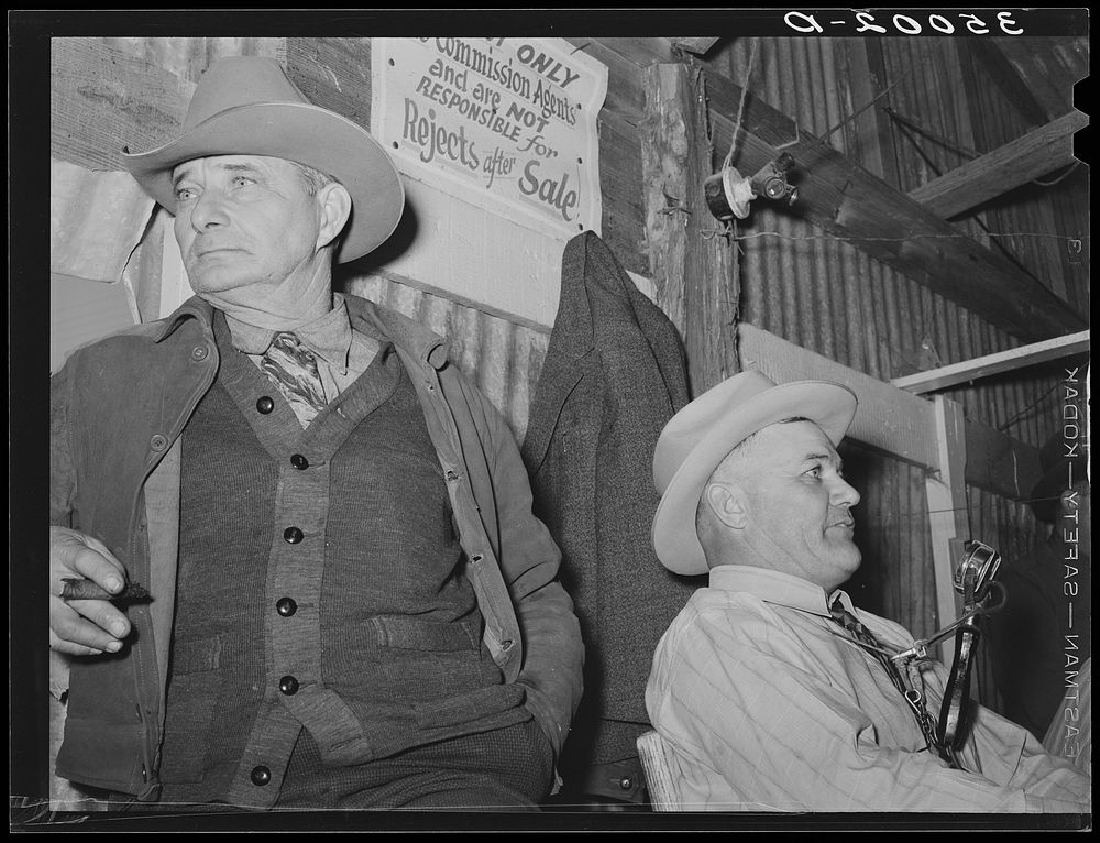 Auctioneer (right) and an official (left) at livestock auction. San Angelo, Texas by Russell Lee