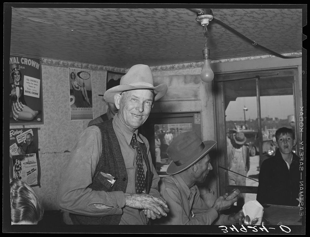 West Texan at eating house at auction. Stockyards, San Angelo, Texas by Russell Lee