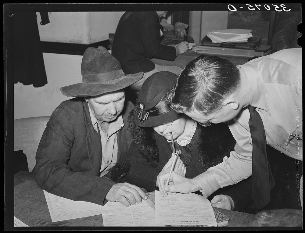 Supervisor helping FSA (Farm Security Administration) clients make out farm and home plans. Mason, Texas by Russell Lee