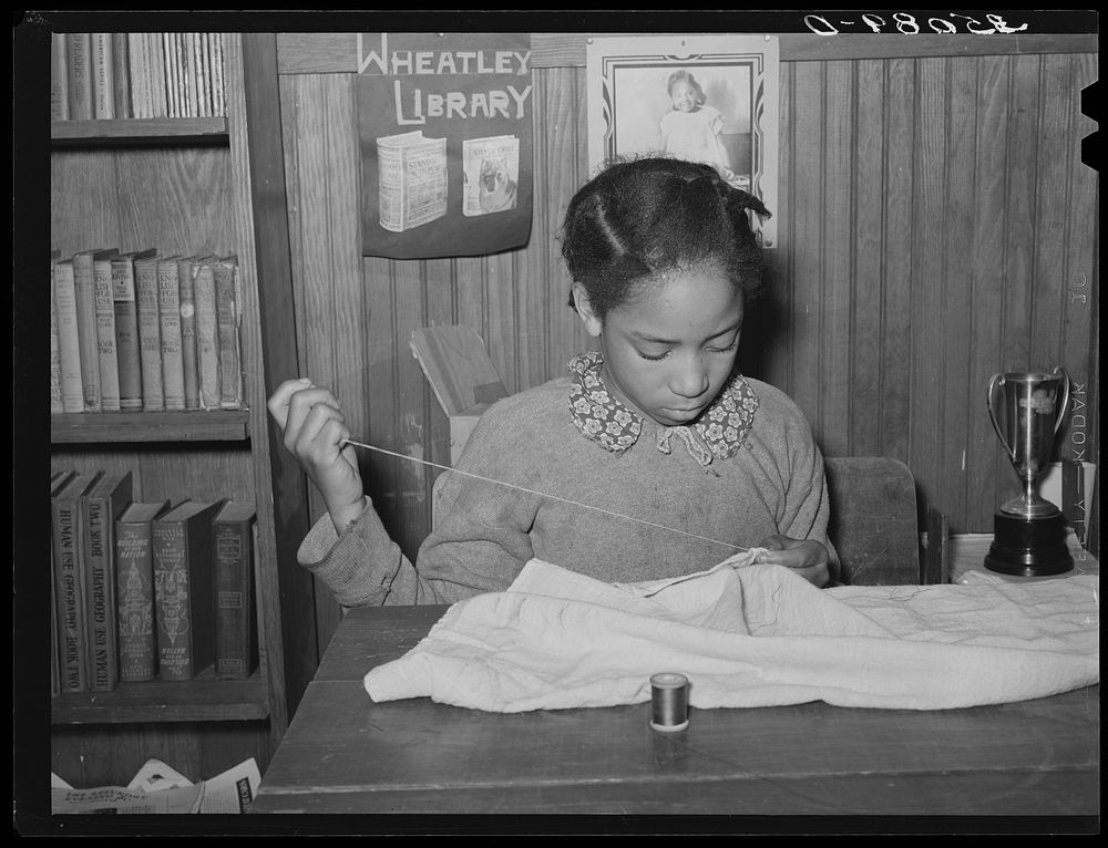 Daughter of Pomp Hall sewing in school. Sewing is her 4-H Club project. Creek County, Oklahoma. See general caption number…