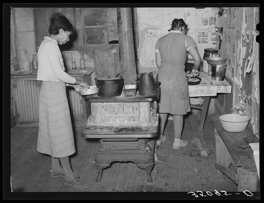 Wife and daughter of Pomp Hall, tenant farmer, preparing supper. Creek County, Oklahoma. See general caption number 23 by…