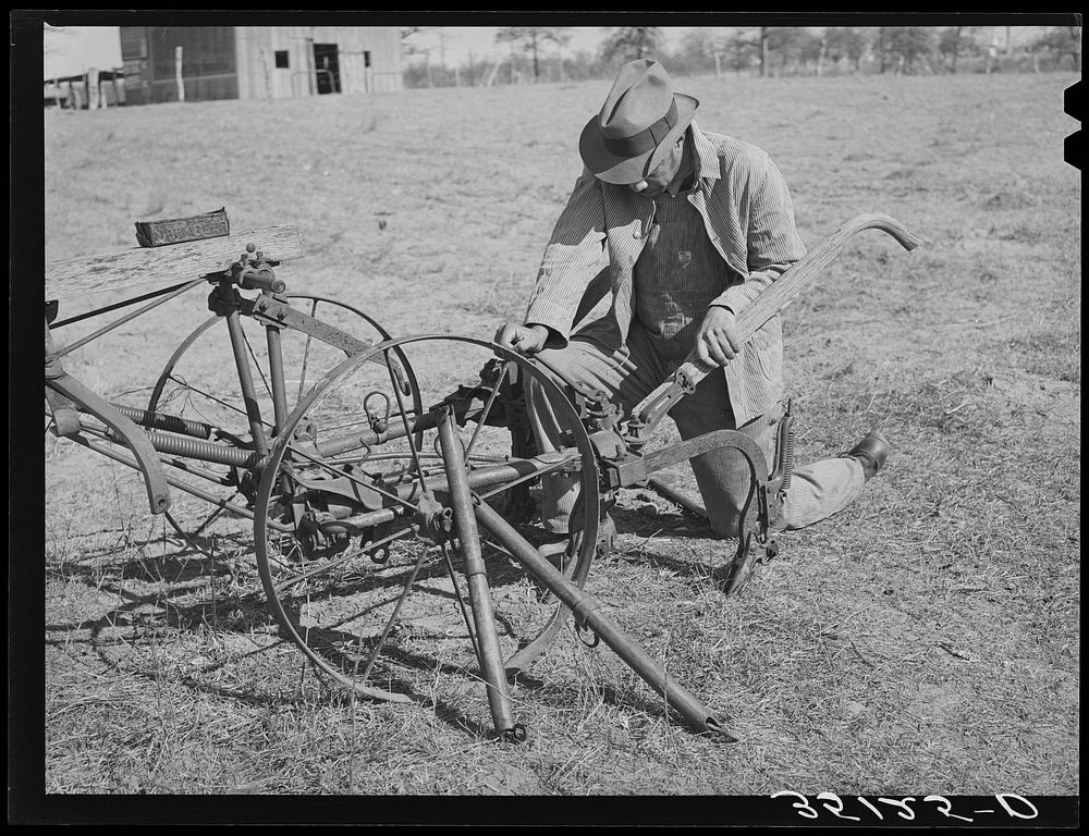 Pomp Hall,  tenant farmer, adjusting his cultivator so it will be in readiness for the spring planting. Creek County…