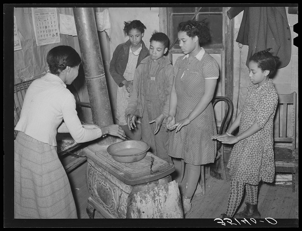 Children of Pomp Hall,  tenant farmer, standing around stove. Creek County, Oklahoma by Russell Lee