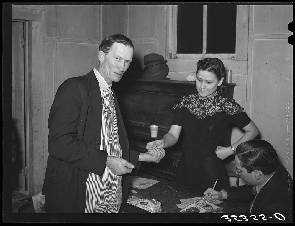 [Untitled photo, possibly related to: Paying for pie which he bought at auction at pie supper in Muskogee County, Oklahoma.…