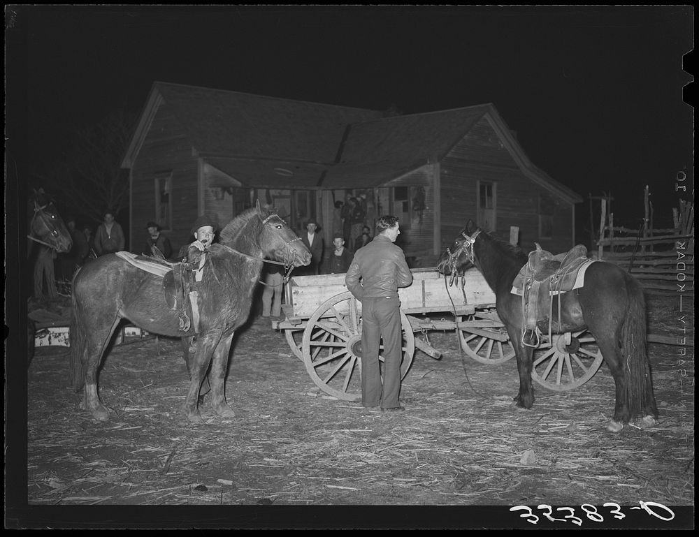 Farm boys trying up their horses at play party in McIntosh County, Oklahoma. See general caption number 26 by Russell Lee