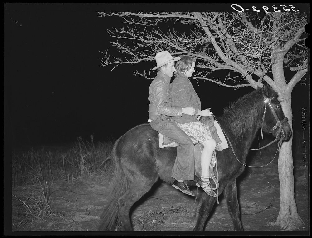Farm boy and girl riding home after the play party. McIntosh County, Oklahoma. See general caption number 26 by Russell Lee