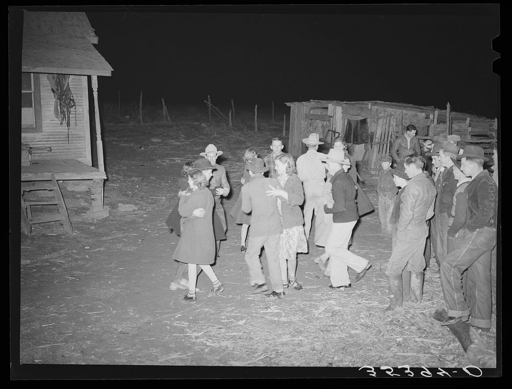 Playing a swing game in the yard. Play party in McIntosh County, Oklahoma. See general caption number 26 by Russell Lee