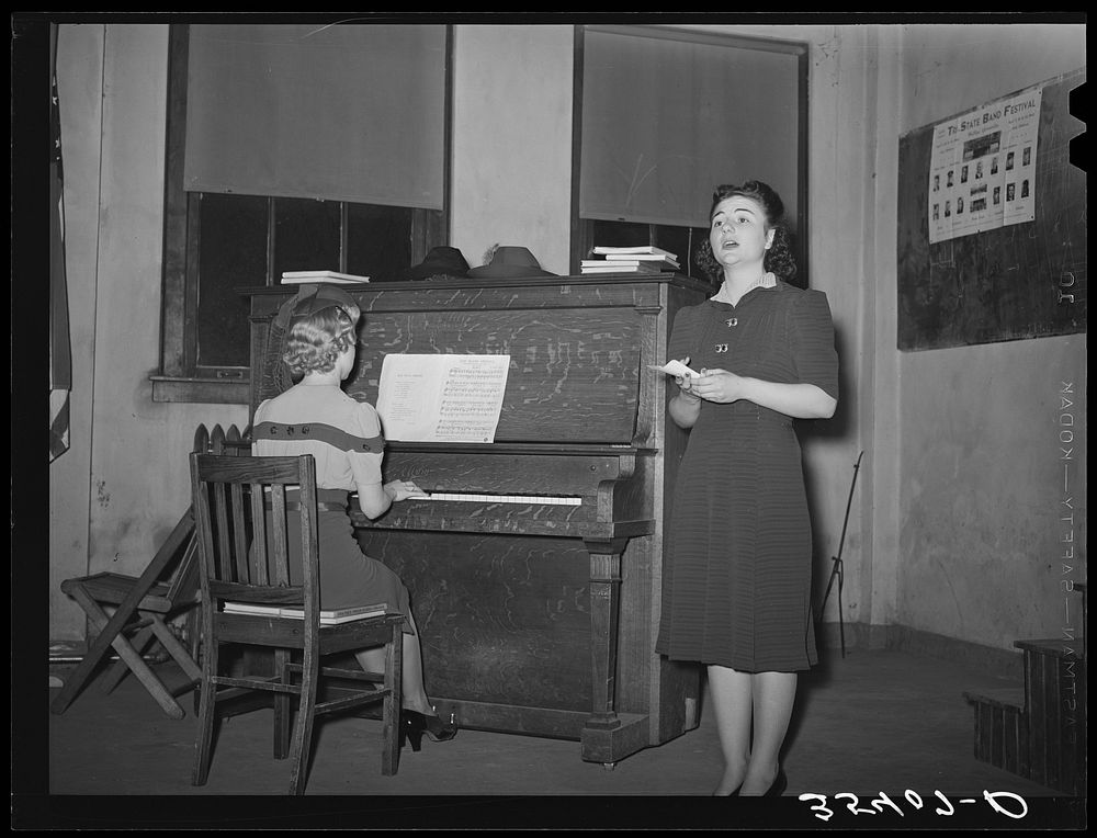 Young lady from nearby college singing at the Jaycee buffet supper and party. Eufaula, Oklahoma. See general caption 25 by…