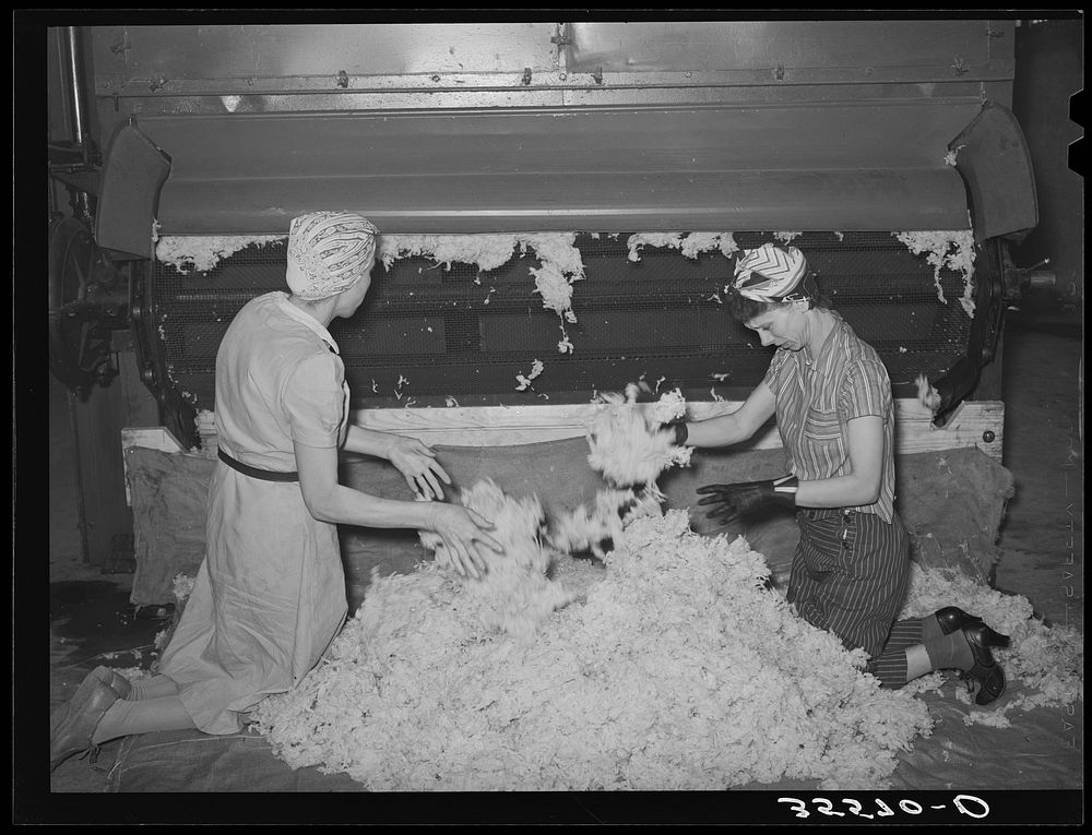 Workers removing scoured and dried wool from machine. Wool scouring plant, San Marcos, Texas by Russell Lee
