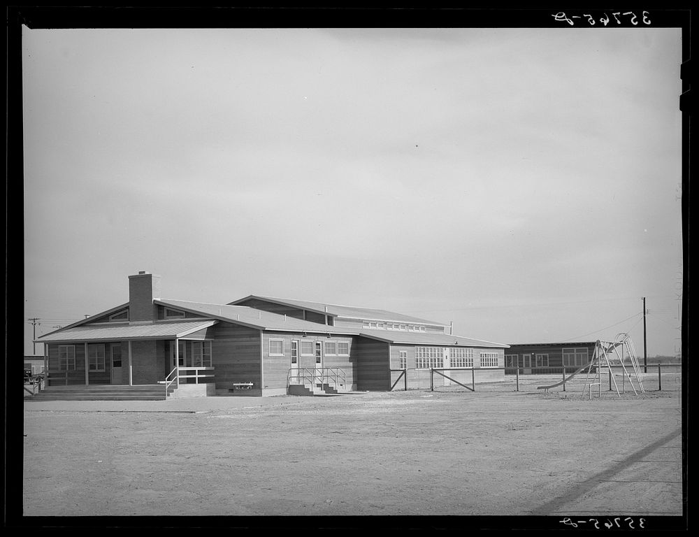 Back of community house and playground at the migratory labor camp. Sinton, Texas by Russell Lee